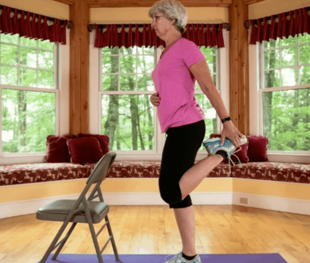 An older woman wearing athletic clothing stretching