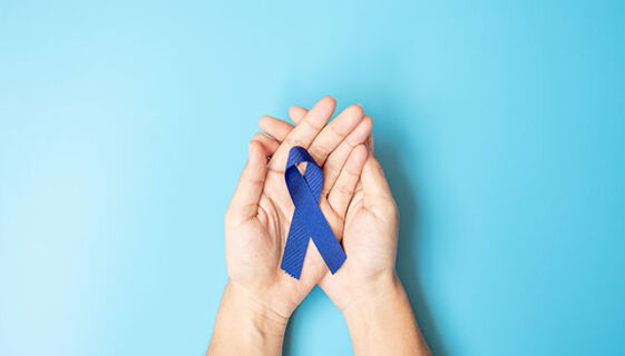Hands holding blue Colorectal cancer ribbon