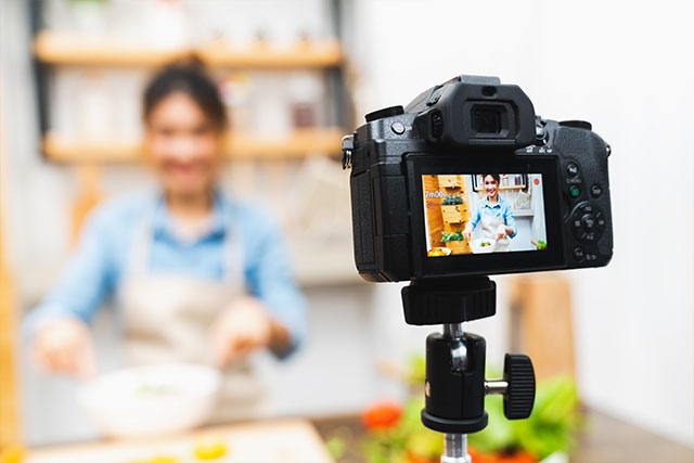 Woman filming herself cooking
