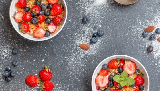 Aerial view of three bowls with fruit and sugar