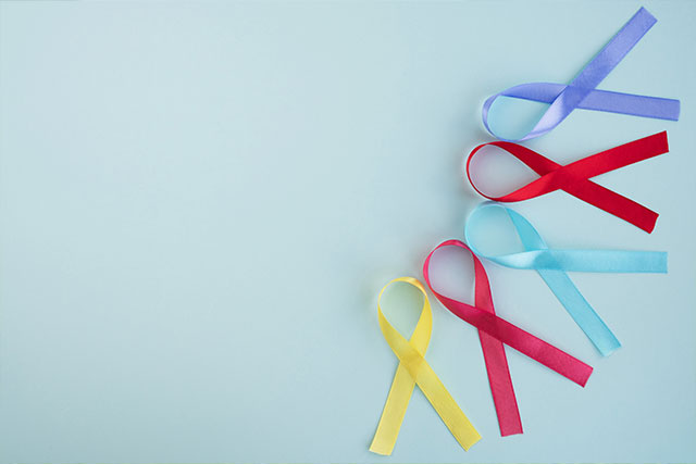 Yellow, red, blue and purple cancer awareness ribbons
