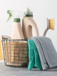 Cleaning supplies in a metal basket